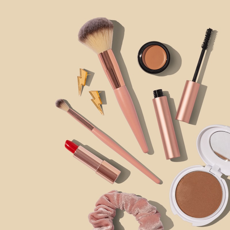 A dark beauty flatlay of cosmetic products